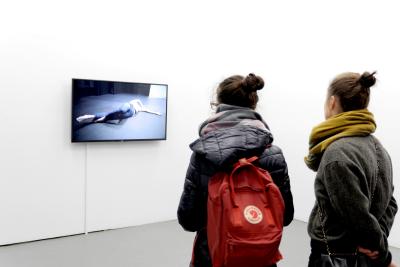 Two people looking at a screen in a gallery